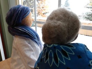 Two cloth dolls watching the snow fall in Prince George, BC.