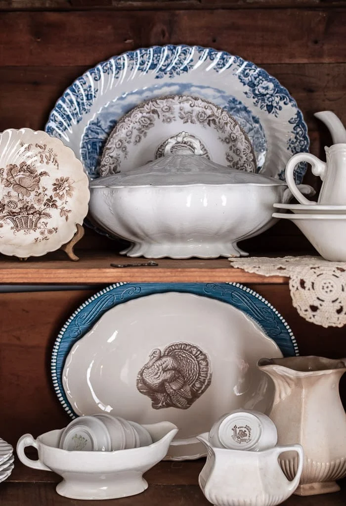 blue, white, brown vintage dishes in hutch