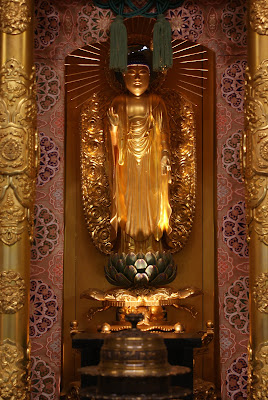 A golden statue of Amida Buddha from the IOBT altar