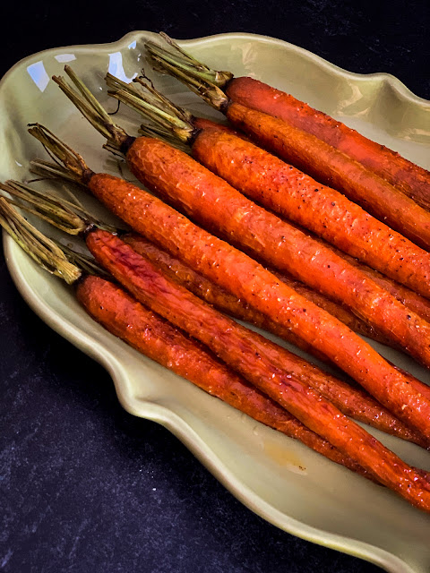 Fun and Easy Roasted Whole Caramelized Carrots, a classic, super simple side dish to grace holiday meals and family dinner tables.  The dish calls for a few straightforward ingredients that enhance the purest flavor of the carrots.