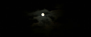 Bright moon behind clouds