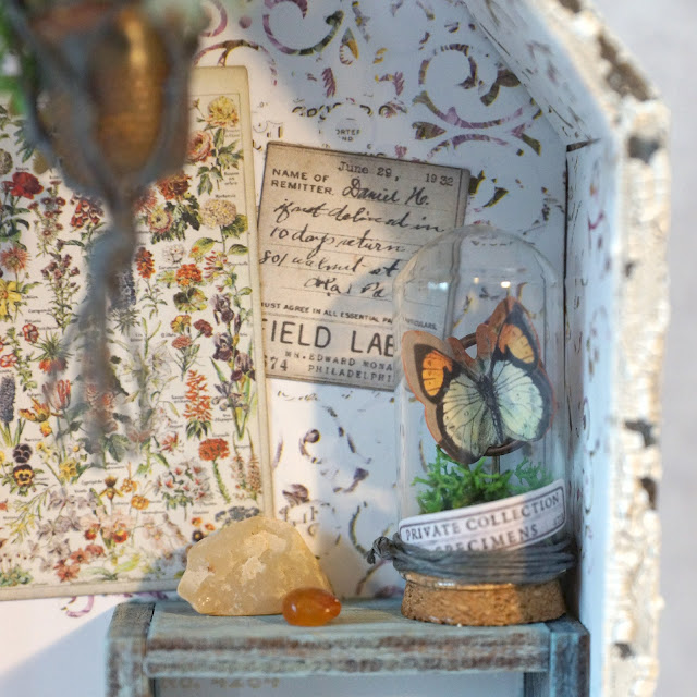 ASW | Tim Holtz Shrine: Shabby Chic Potting Shed Miniature with Speckled Egg and Field Notes details.