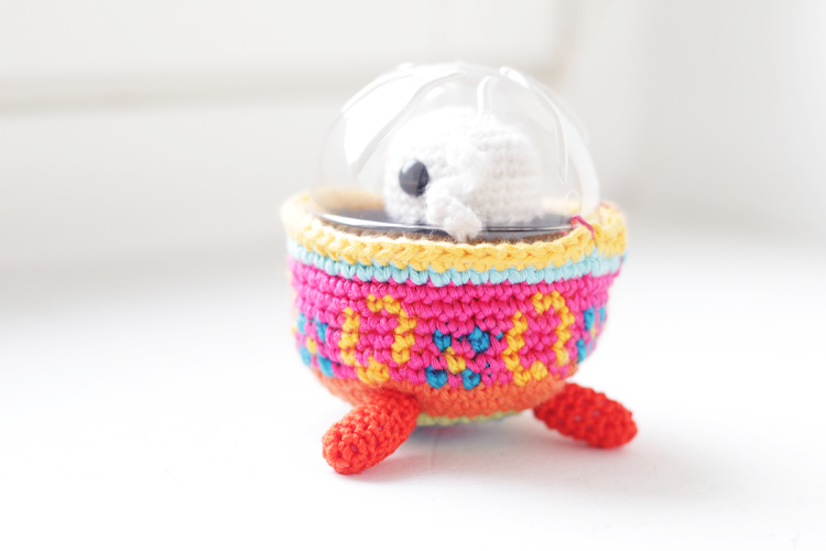 Easter bunny in colored egg spaceship amigurumi