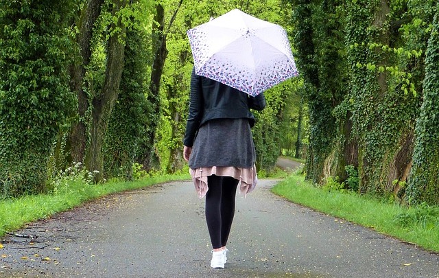 Woman Walking Down a Path, Alone, with Umbrella