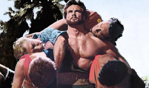 Hercules (Steve Reeves) carries four Argonauts back to their ship, escaping eventual death from the Amazons in HERCULES (1958)