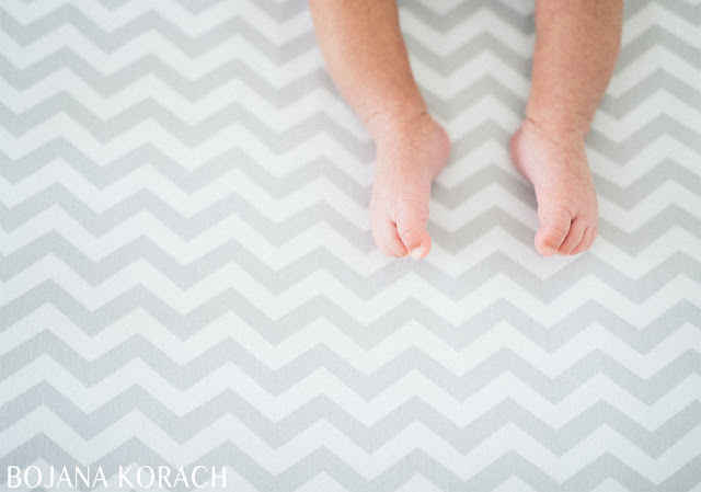 san francsico based photographer bojana korach captures baby feet on a chevron patterned bedding