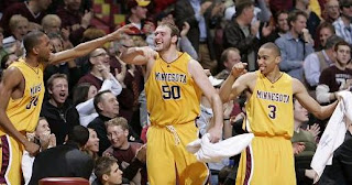 Members of the Gophers basketball roster celebrate a great play