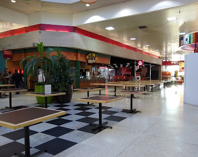 The deserted mall food court, with no chairs or people