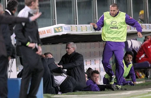 Fiorentina coach Delio Rossi is seen fighting with one of his own players Adem Ljajić