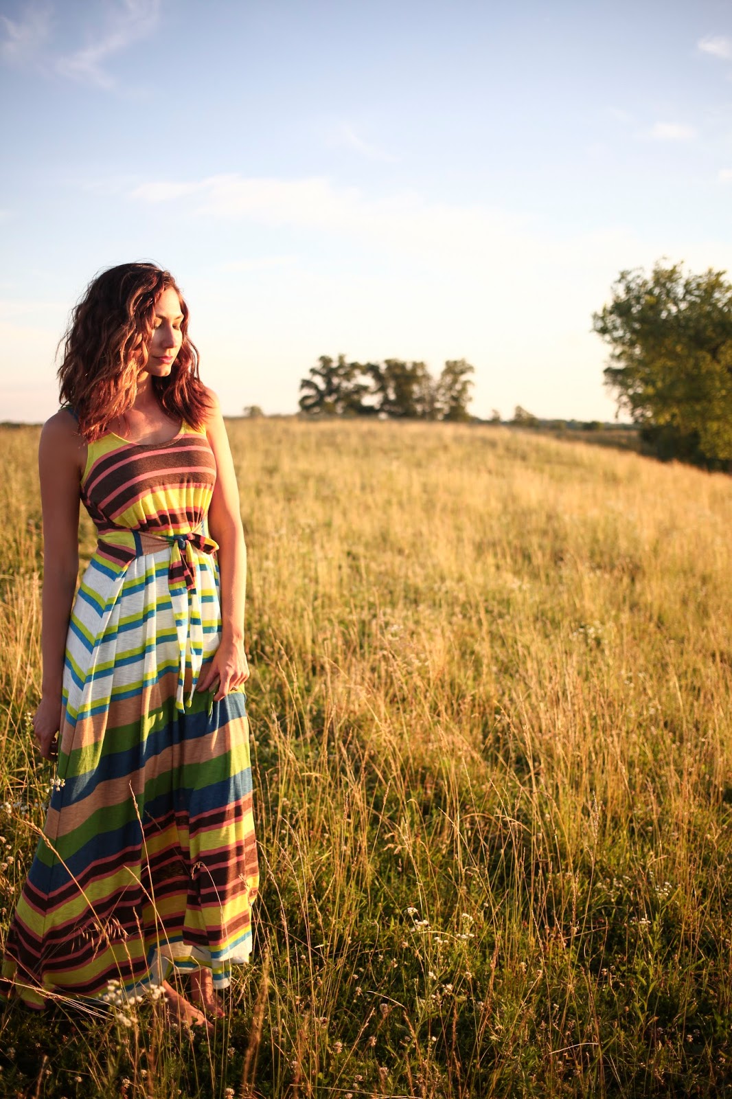 Amy West wearing multi colored striped maxi dress