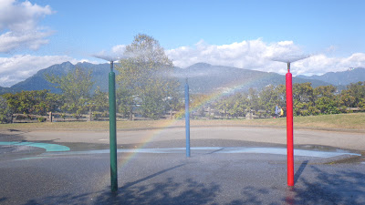 Rainbow near Water Park fountains in a sunny day of september