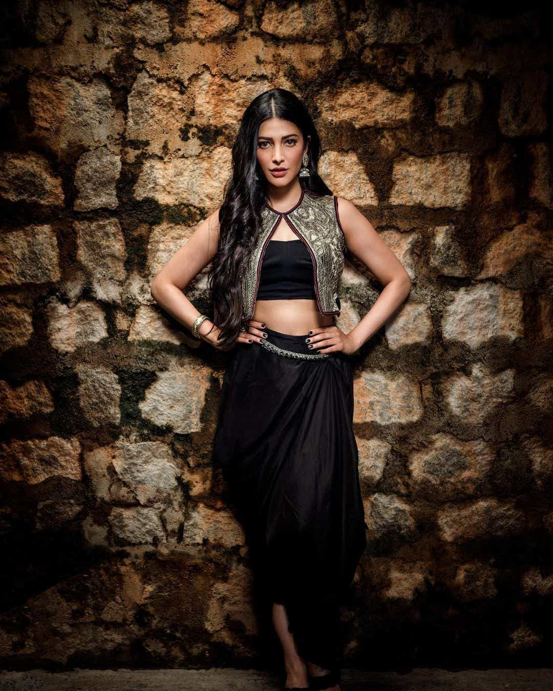 Actress Shruti Haasan looks captivating in a black dress photoshoot. Download high-resolution images for free.