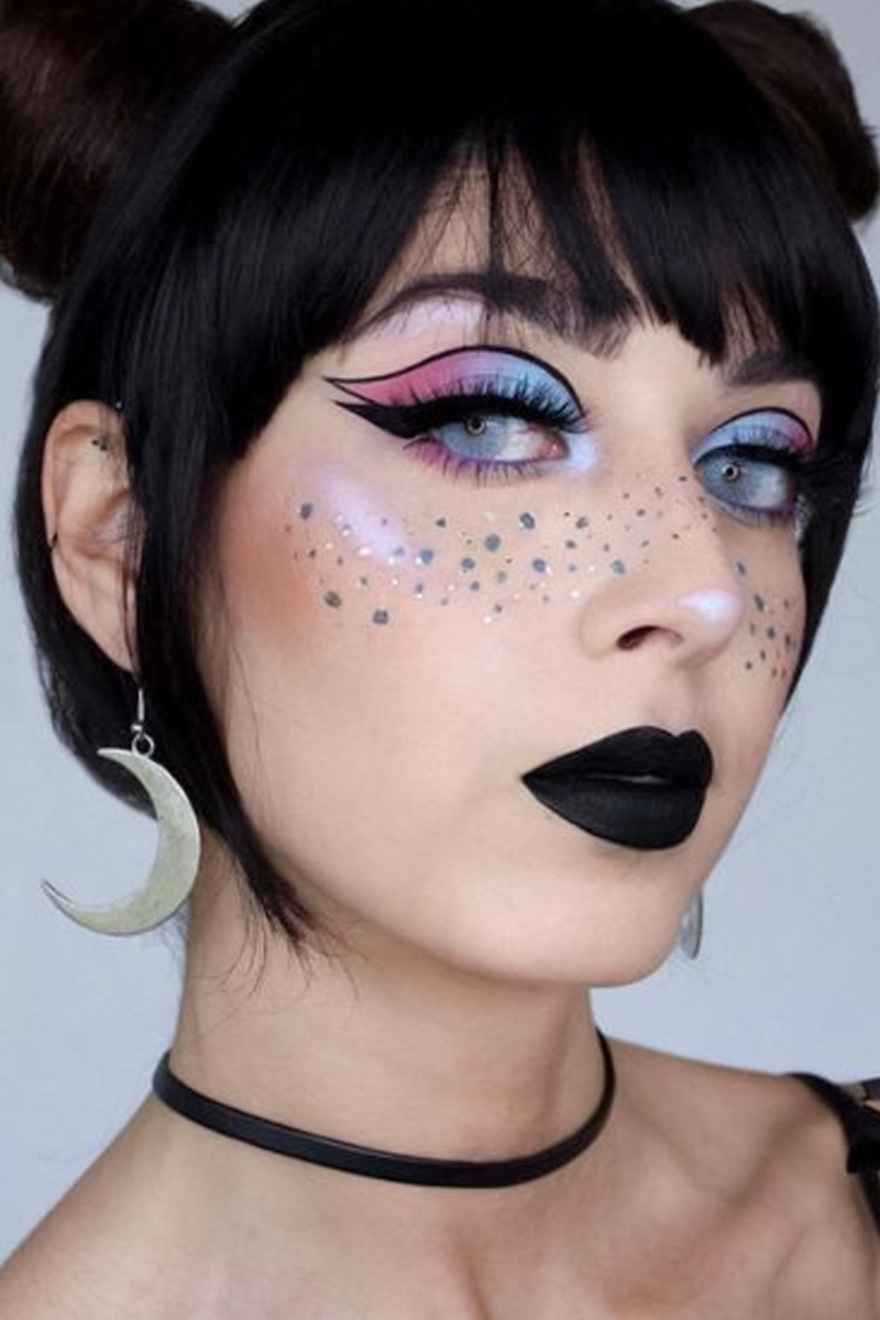 pretty selfie of a young woman with pastel goth makeup look and faux freckles