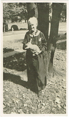 Cassie Davis standing outside her home in Erwin TN holding a white rabbit