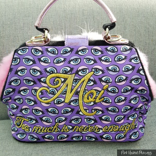 back of handbag in purple eye print material with embroidery details