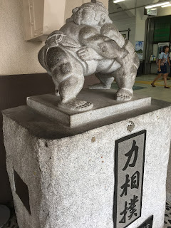 Statue showing two sumo wrestlers at the entrance to Ryogoku Station