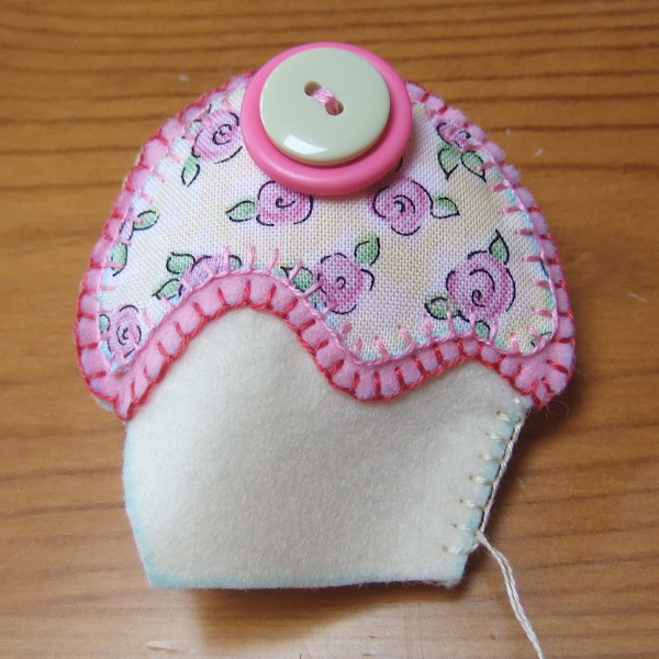 Stitching the edges of a felt ornament plush while filling with fiber