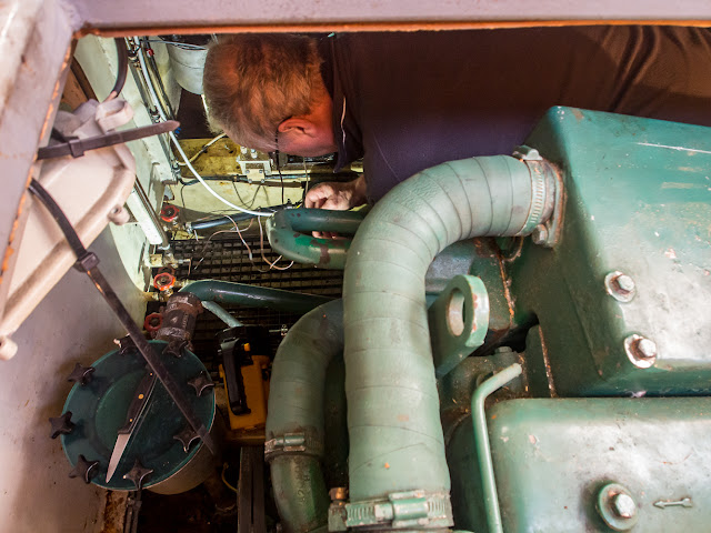 Photo of Phil preparing the wiring for the new bilge pump in the engine room