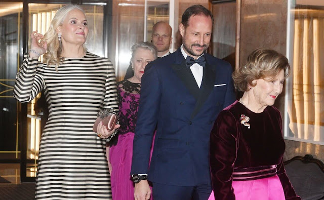 Crown Princess Mette-Marit wore a cream and antracite stripe maxi dress by Noella. Queen Sonja wore a fuchsia satin skirt