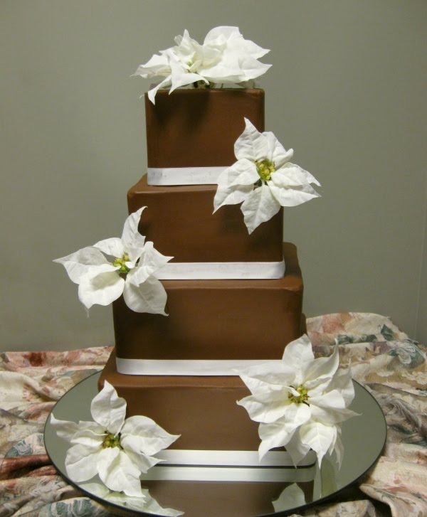 This wedding cake is decorated with sugar snow flakes and beautiful red 