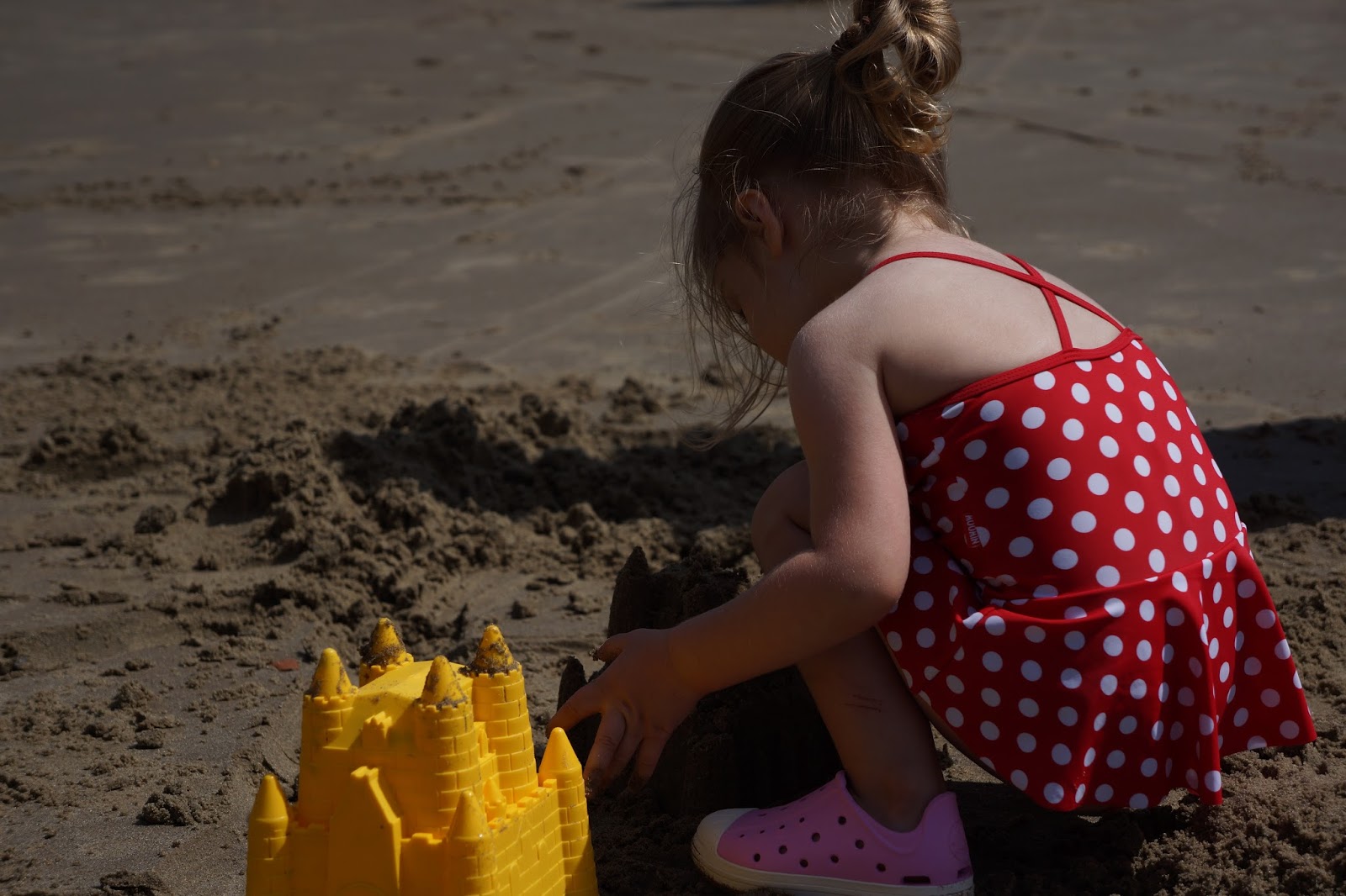 toddler building a sand castle