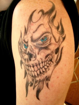 skull on fire tattoos, arm upper tattoo, popular tattoo style