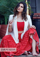 zarine khan, hot photo zarine khan, she is sitting with bare feet and with big nose ring, white coat