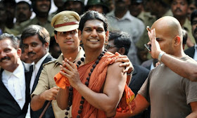 Police escort Hindu ‘godman’ Nithyananda to a bail hearing in 2012. Photograph: Manjunath Kiran/AFP via Getty Images