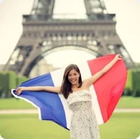A young lady flying a French flag