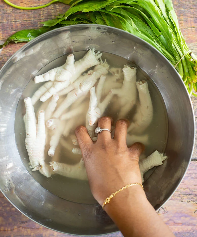 Image of chicken feet being washed in water and vinegar.