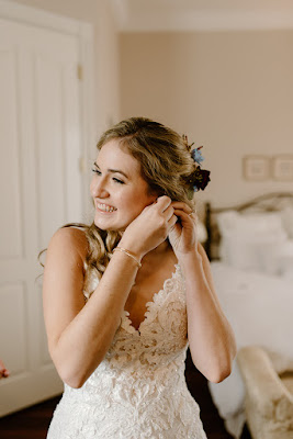 bride putting on earrings