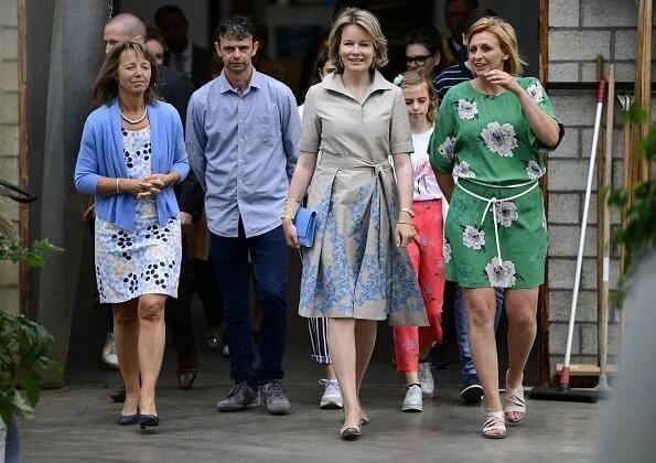 Queen Mathilde visited a farm breeds cattle, grows crops and strawberries and focuses on green care. beige cotton midi shirt dress embroidered