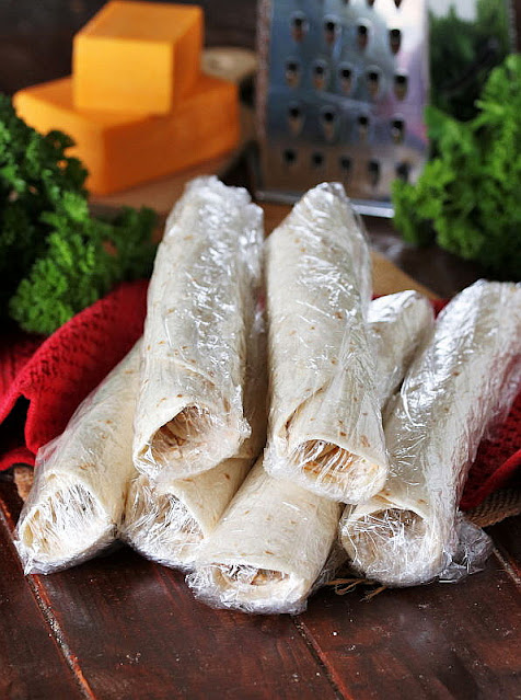 Prepared Bacon-Cheddar Ranch Roll-Ups Wrapped in Plastic Wrap Image