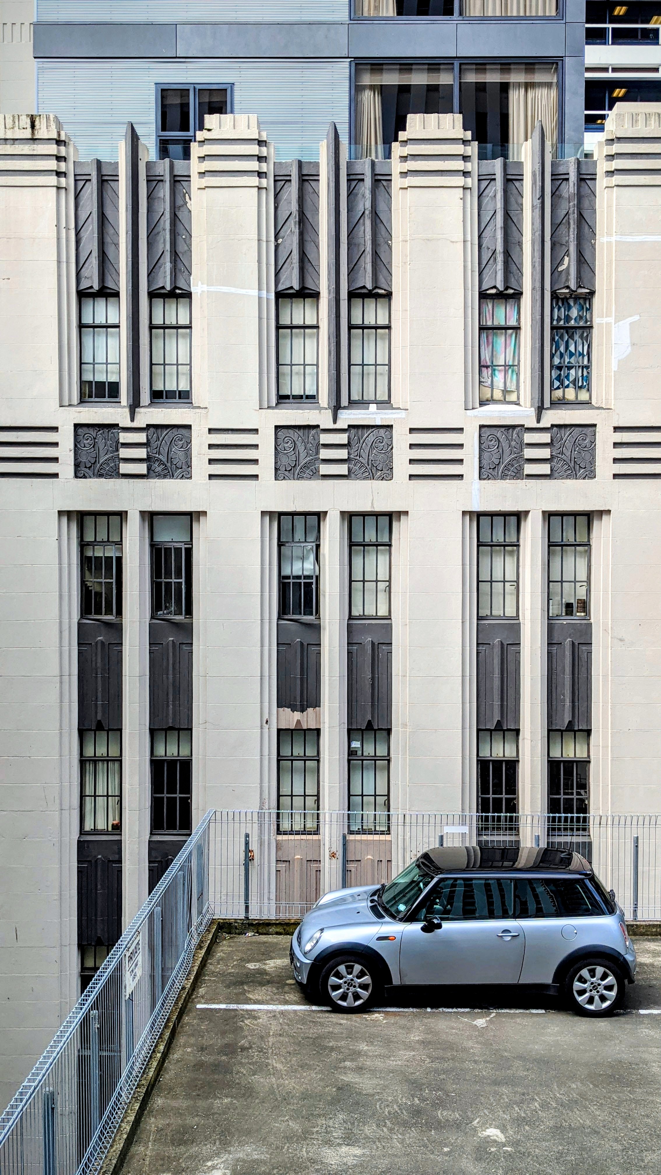 Car parked on a roof against an art deco high-rise backd