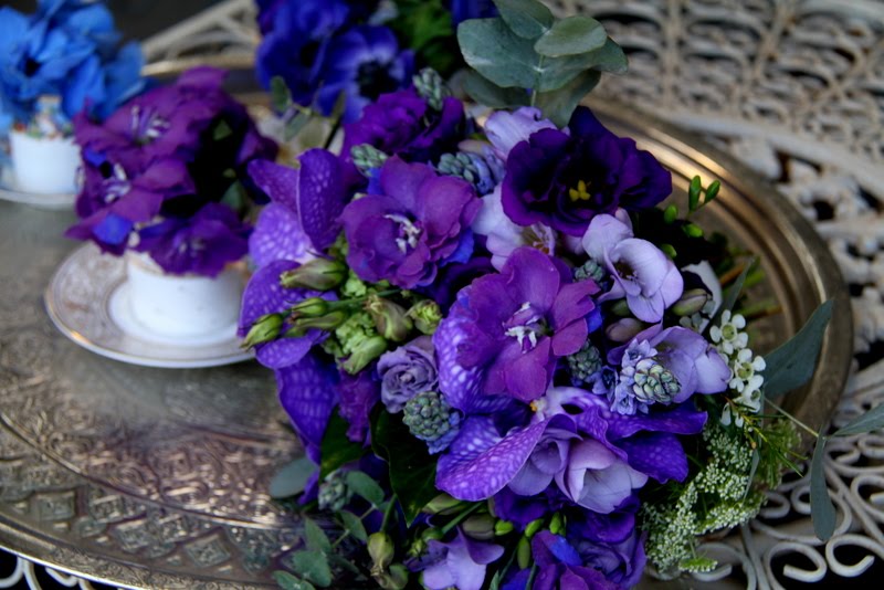 The blue cup has a tiny posy of blue Hydrangeas the gold cup purple