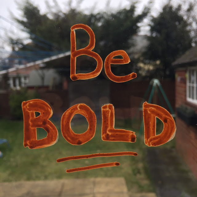 Be Bold typography on window using chalk markers