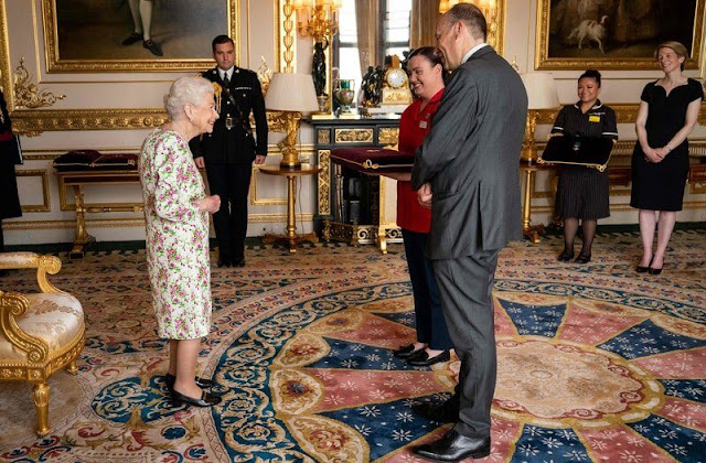 The Queen presented the representatives from the National Health Services. Elizabeth wore a floral print dress