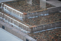 zoom photo of rock and water fountain from above