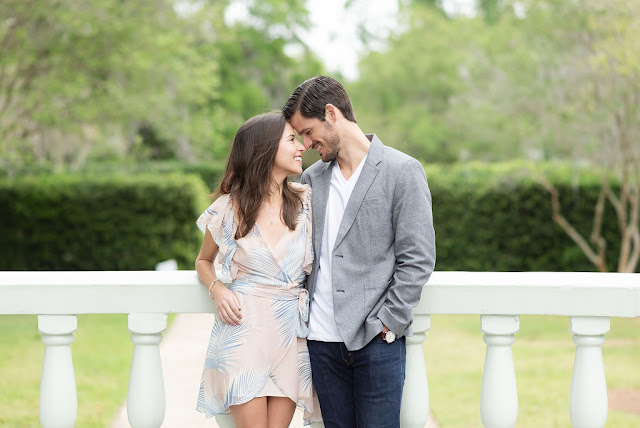 couple smiling against wall