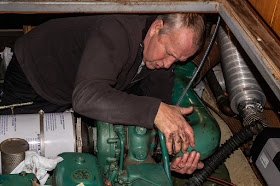 Photo of Phil refitting the exhaust elbow on Ravensdale's port engine