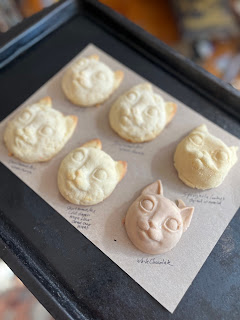 cat face cookies on baking tray