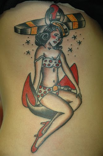 Girl on anchor tattoo.