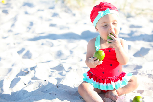 infant in watermelon bathing suit