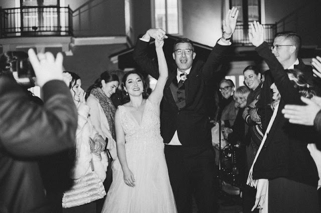 bride and groom dancing with their hands in the air