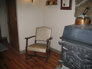 an old low back rocking chair with vinyl type upholstery