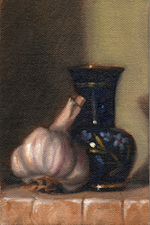 Oil painting of a garlic bulb beside a blue glass vase painted with a floral pattern.