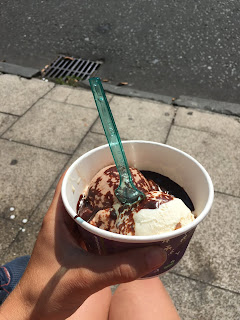 Ice cream and hot fudge sauce in a tub.