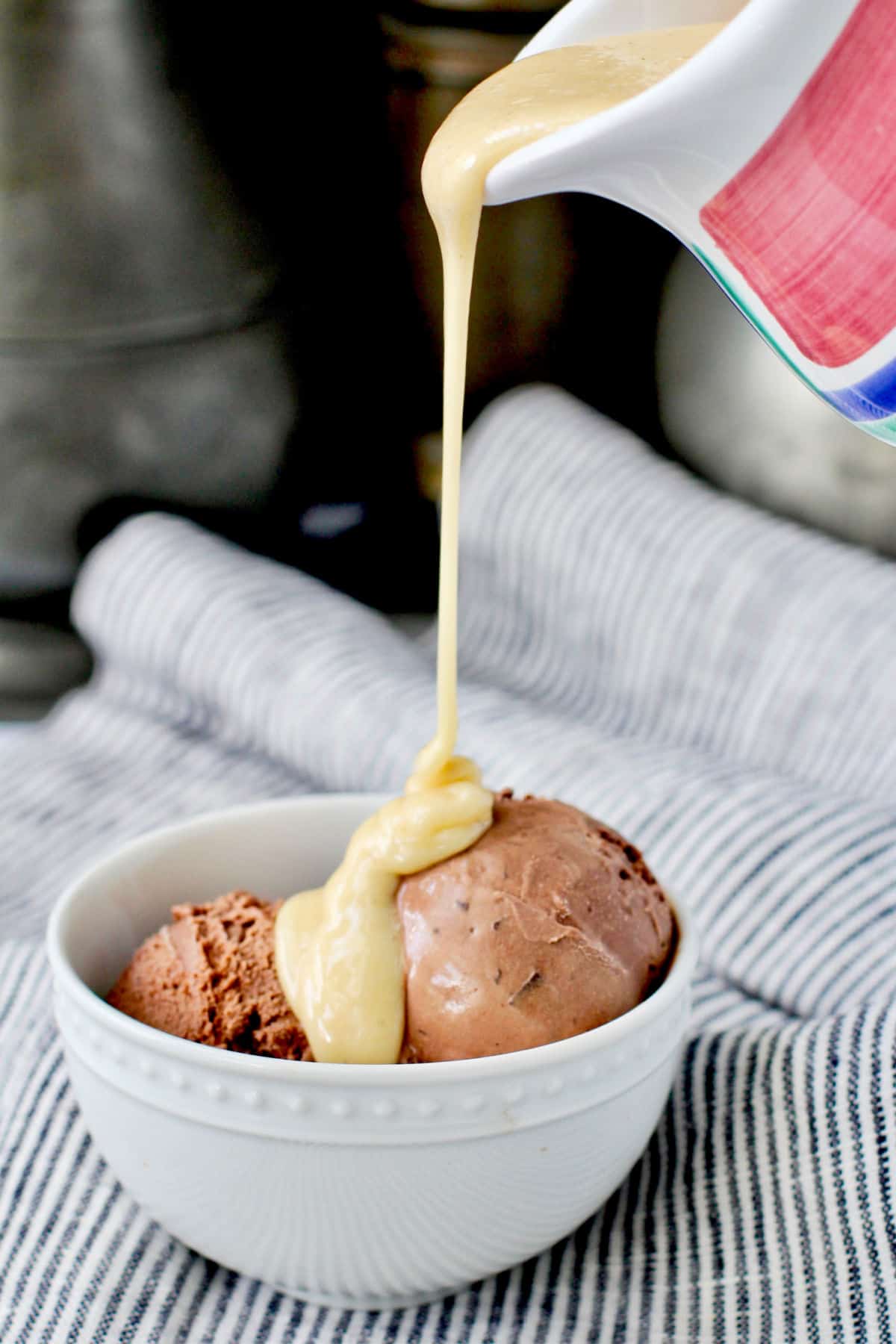 White Chocolate Fudge Sauce poured over chocolate ice cream.