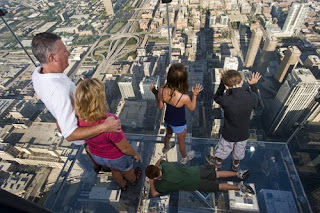 Family in The Ledge glass balcony on Willis Tower, Chicago