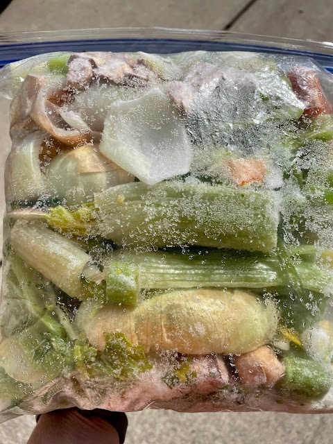 Freezer bag full of vegetable scraps.